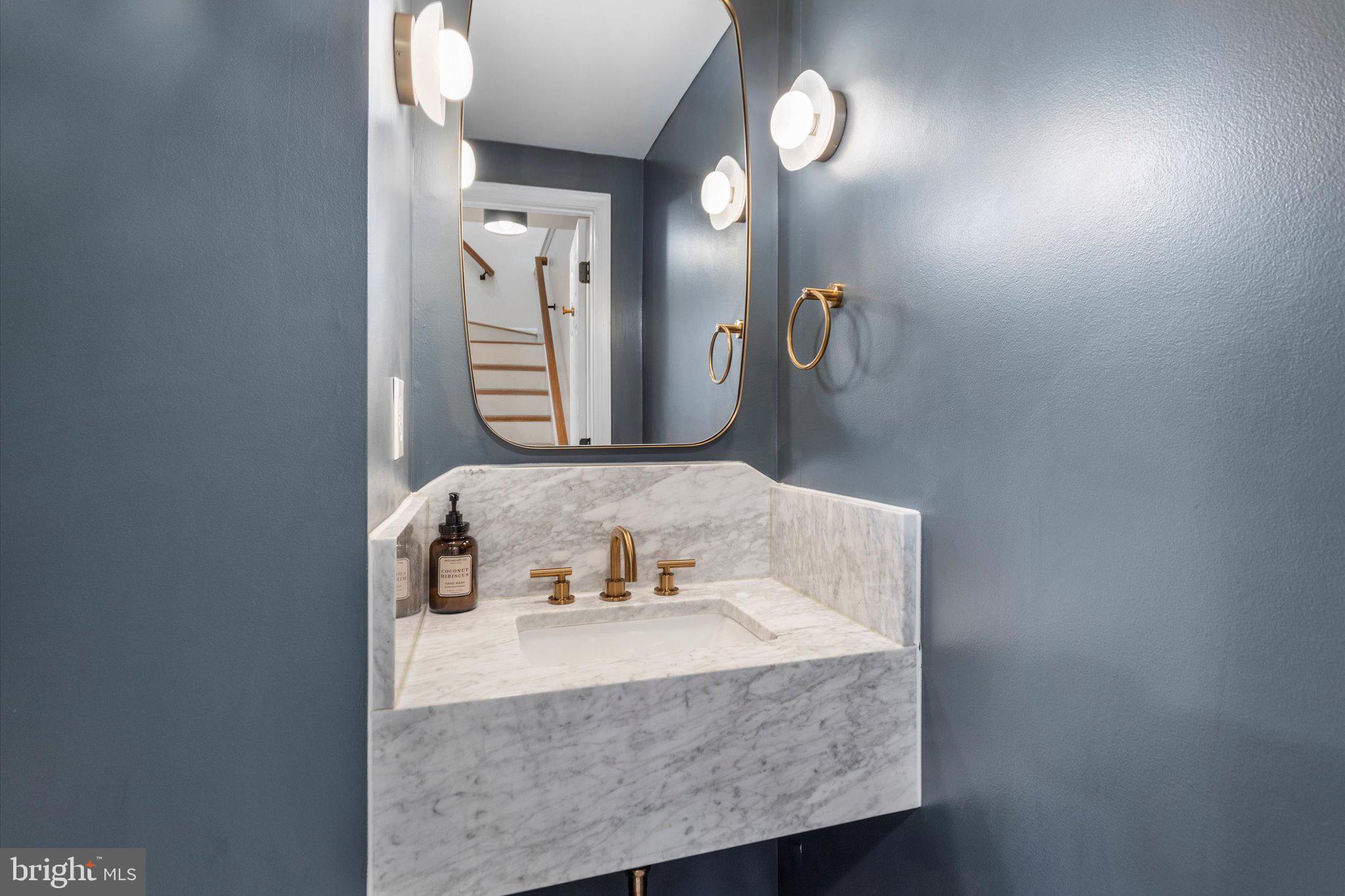 6105 Starburn Path Columbia, MD 21045 - Photo 11 of 30 a bathroom with a granite countertop sink and a mirror