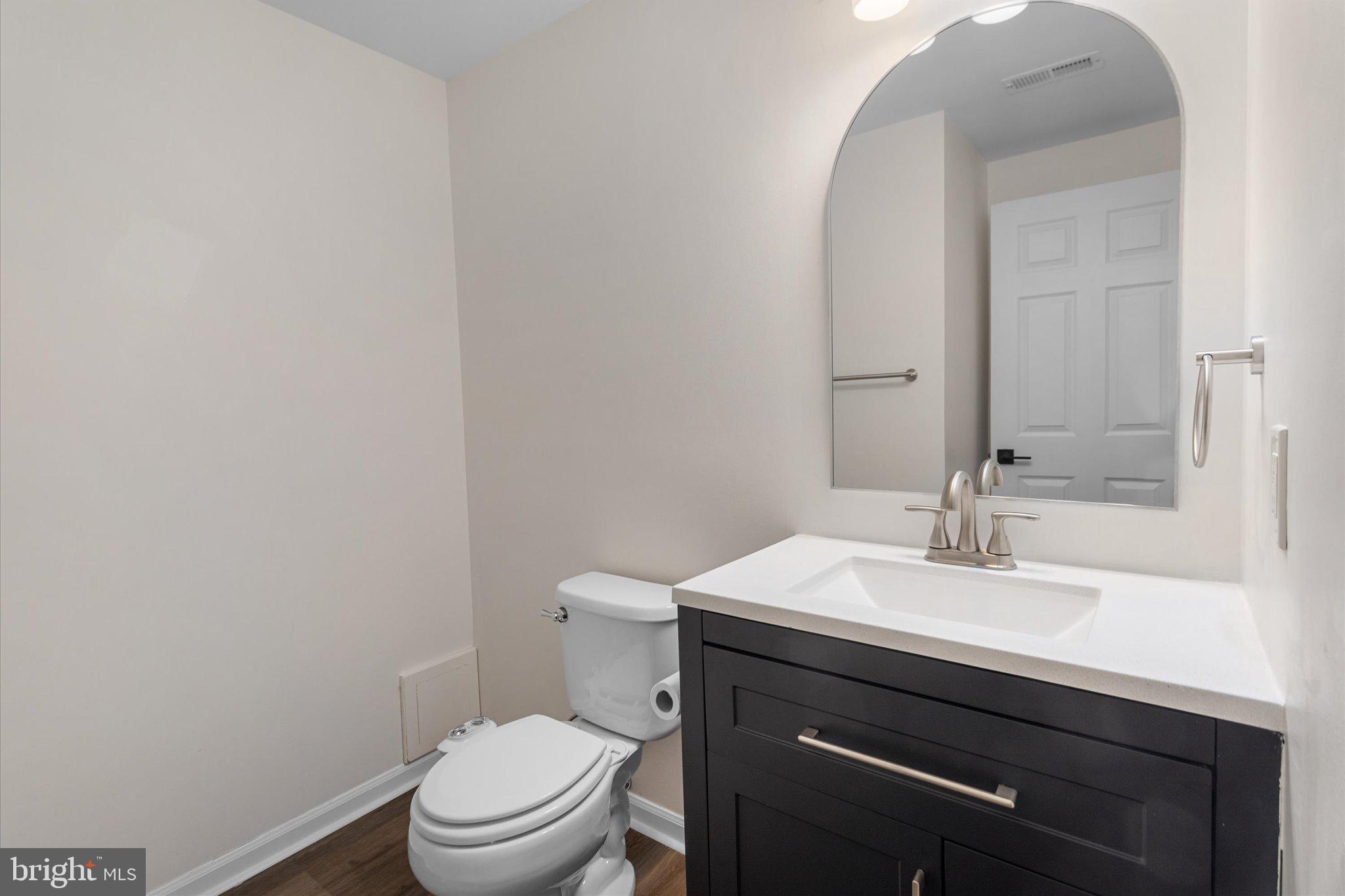 6105 Starburn Path Columbia, MD 21045 - Photo 25 of 30 a bathroom with a sink a toilet and mirror