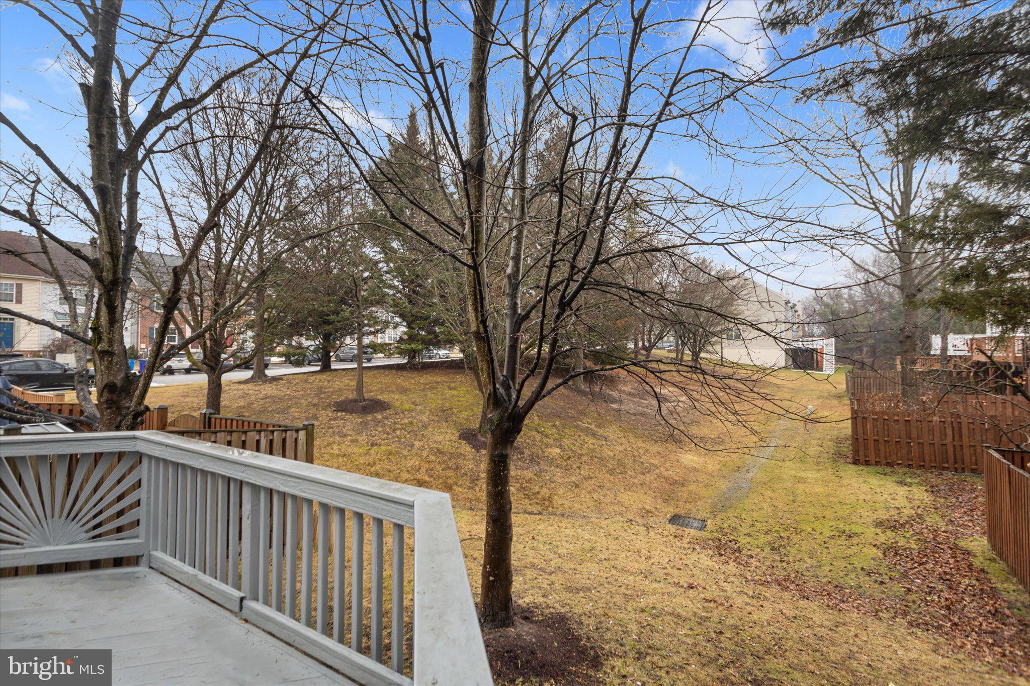 6105 Starburn Path Columbia, MD 21045 - Photo 29 of 30 a view of a yard with wooden fence and large trees