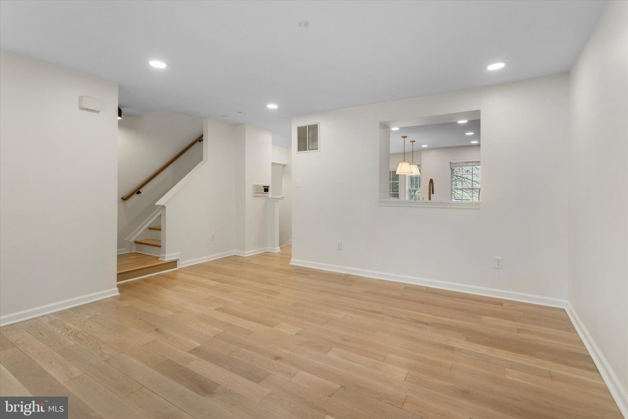 6105 Starburn Path Columbia, MD 21045 - Photo 6 of 30 a view of an empty room with wooden floor and stairs