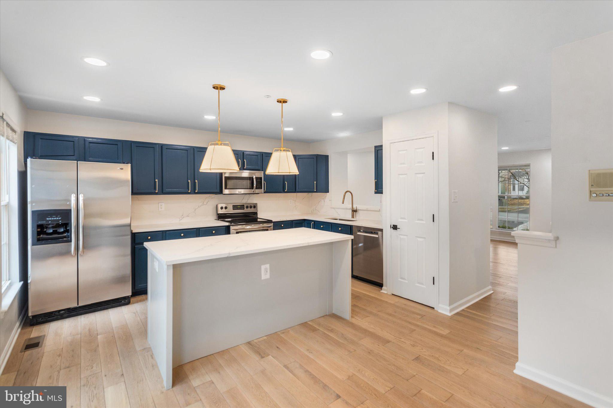 6105 Starburn Path Columbia, MD 21045 - Photo 8 of 30 a kitchen with stainless steel appliances a refrigerator sink and microwave