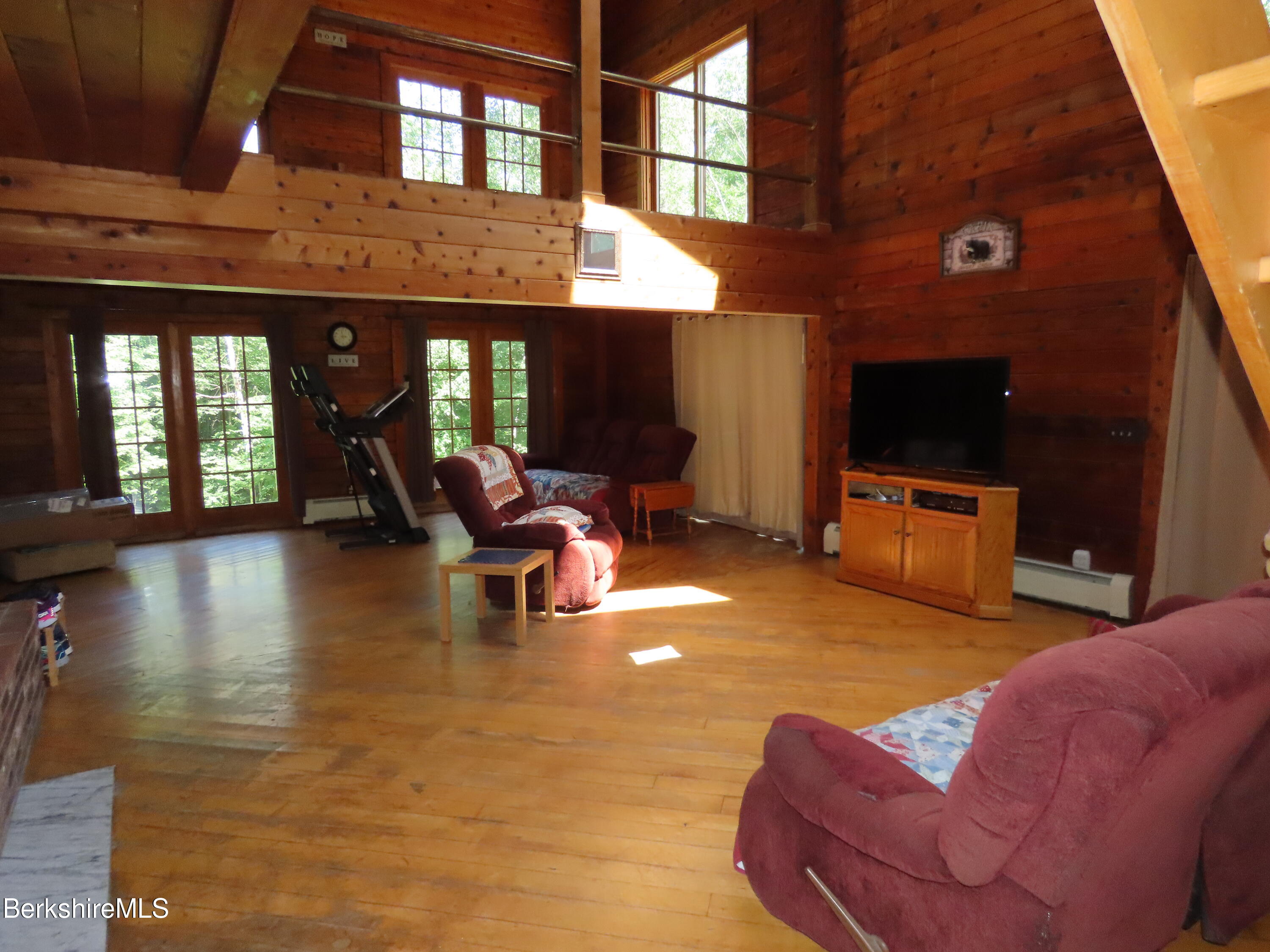 460 Sparrow Drive Stamford, VT 05352 - Photo 18 of 79 a living room with furniture a fireplace and a flat screen tv