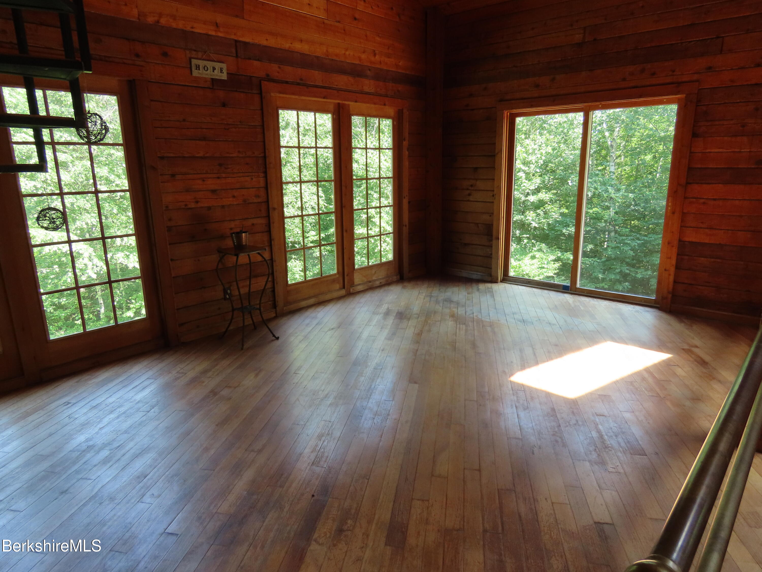 460 Sparrow Drive Stamford, VT 05352 - Photo 26 of 79 an empty room with wooden floor and windows