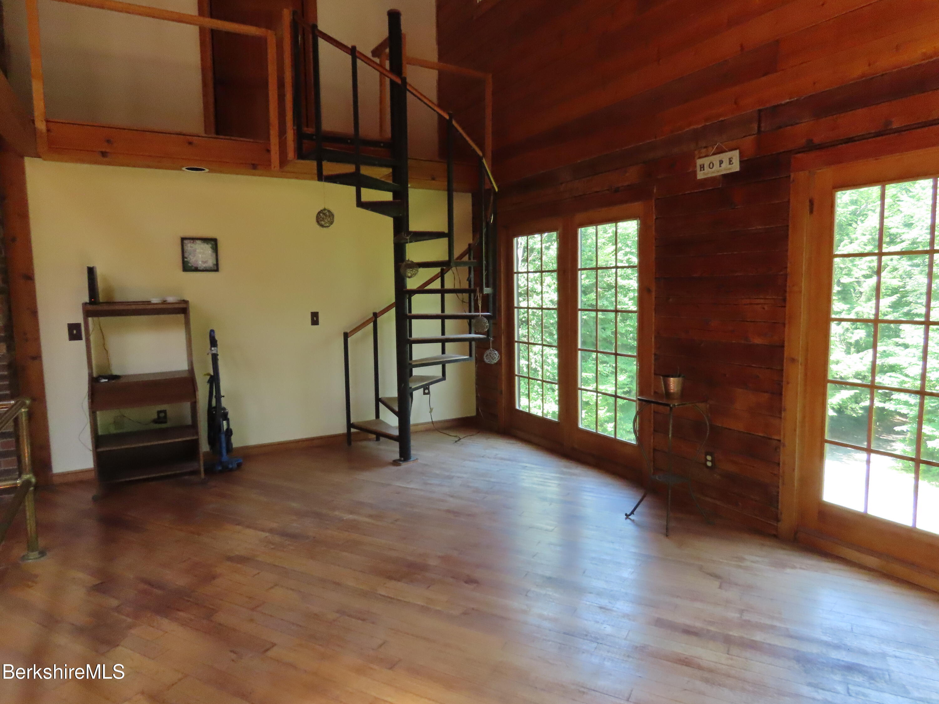 460 Sparrow Drive Stamford, VT 05352 - Photo 27 of 79 an empty room with wooden floor and windows