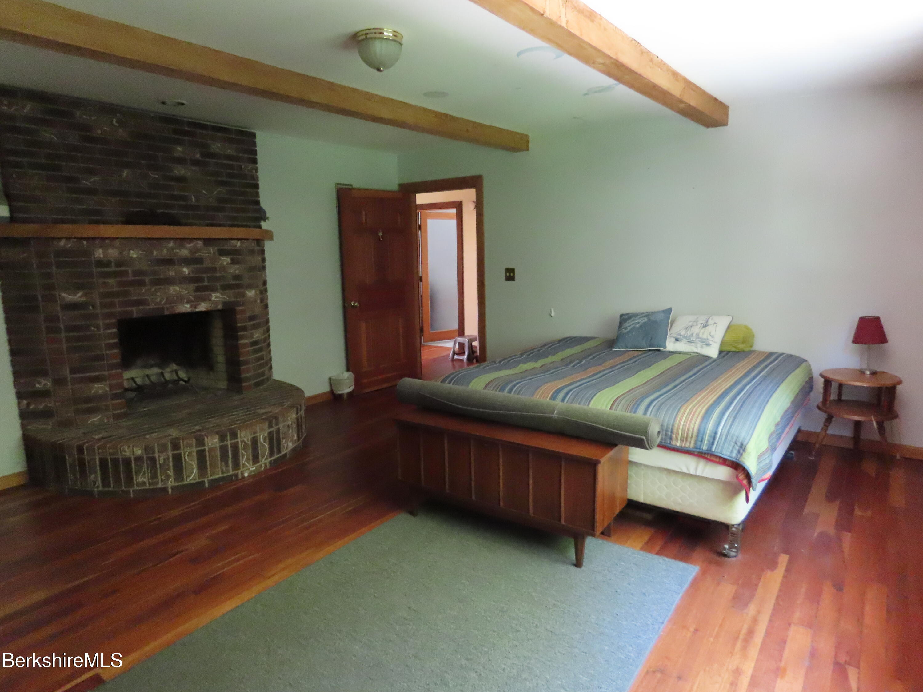 460 Sparrow Drive Stamford, VT 05352 - Photo 35 of 79 a bedroom with a bed and a fireplace
