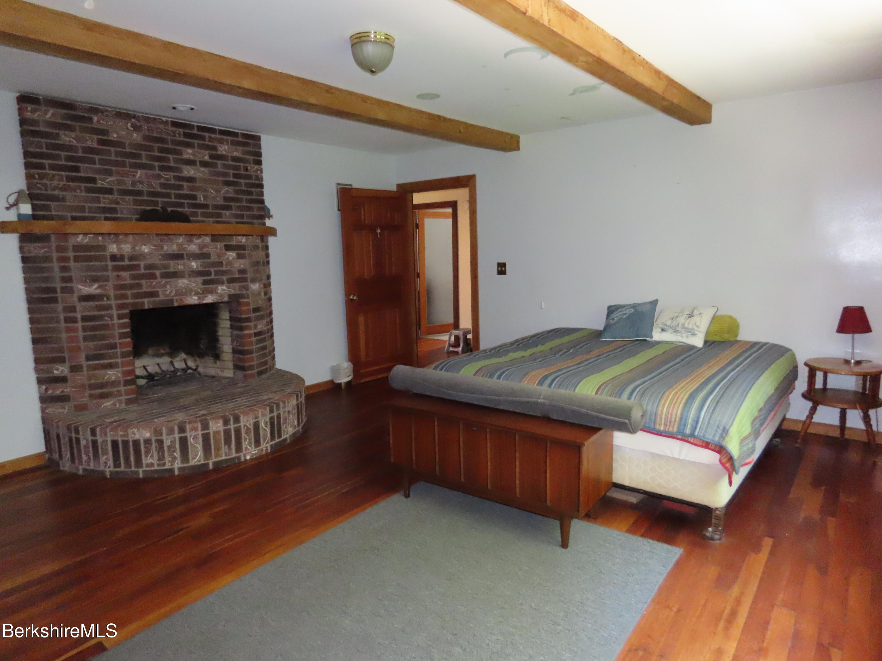 460 Sparrow Drive Stamford, VT 05352 - Photo 37 of 79 a bedroom with a bed and a fireplace