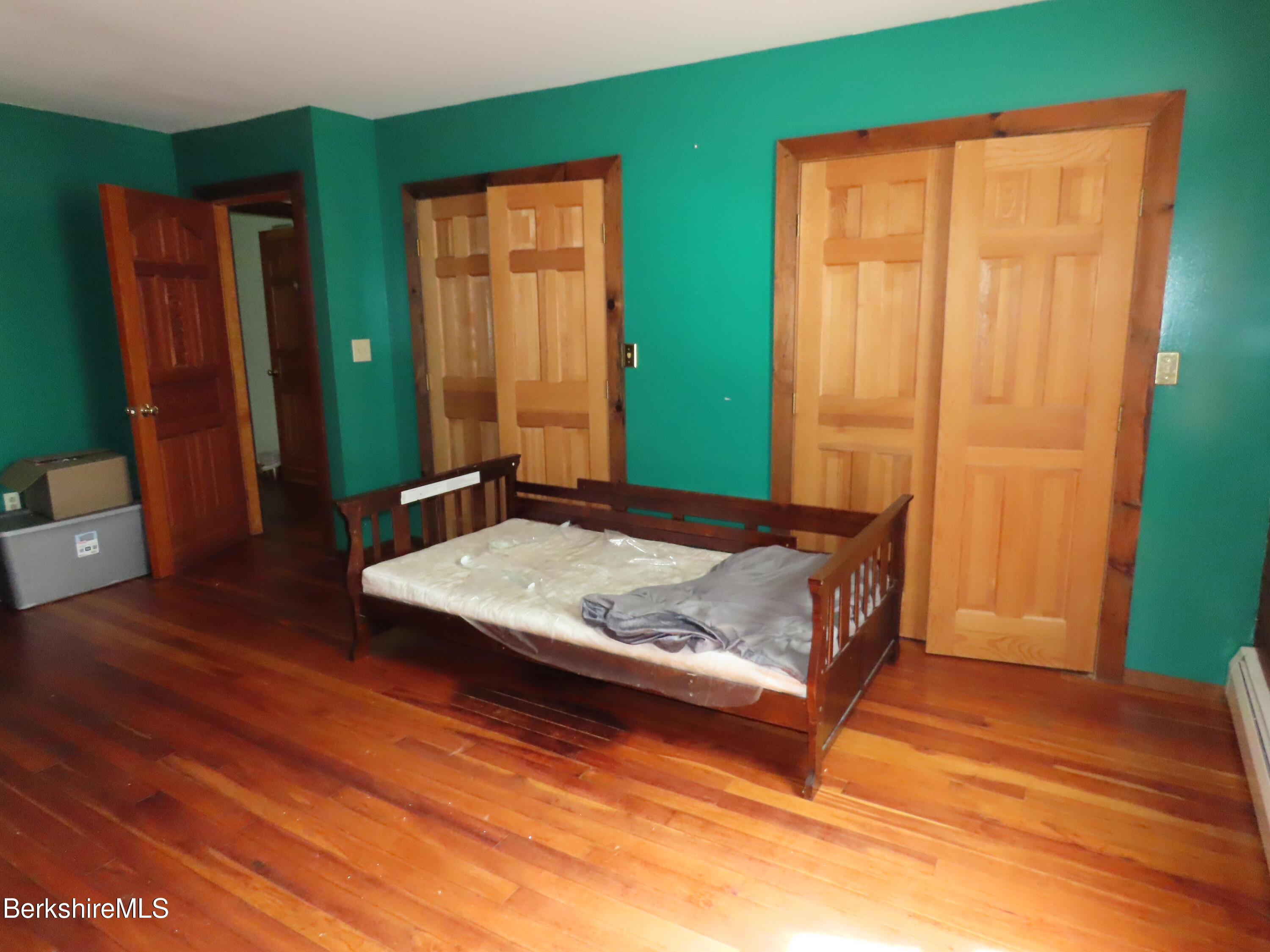 460 Sparrow Drive Stamford, VT 05352 - Photo 54 of 79 a bed sitting in a room next to a wooden door