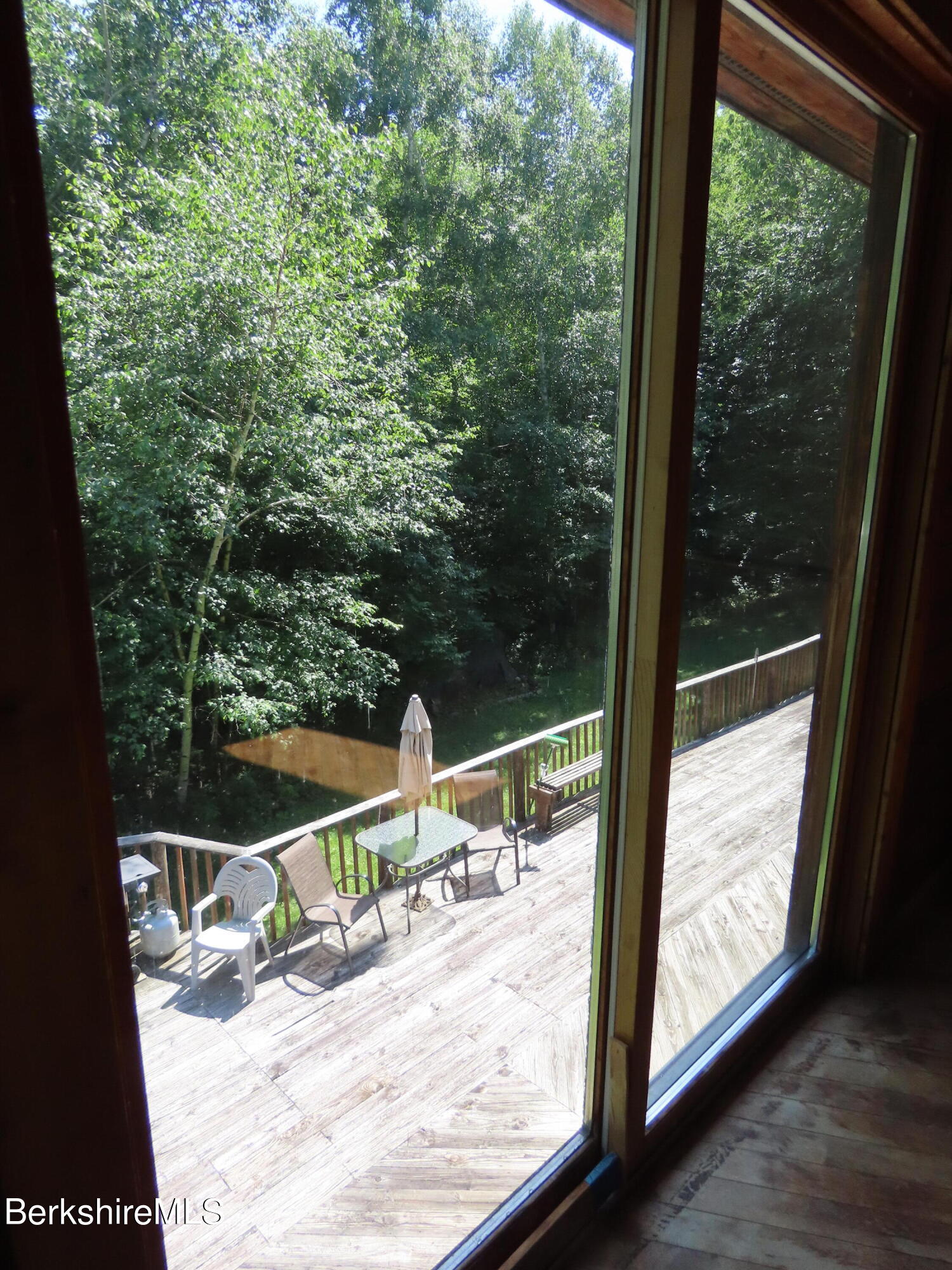 460 Sparrow Drive Stamford, VT 05352 - Photo 55 of 79 a view of a balcony with floor to ceiling window wooden floor and fence