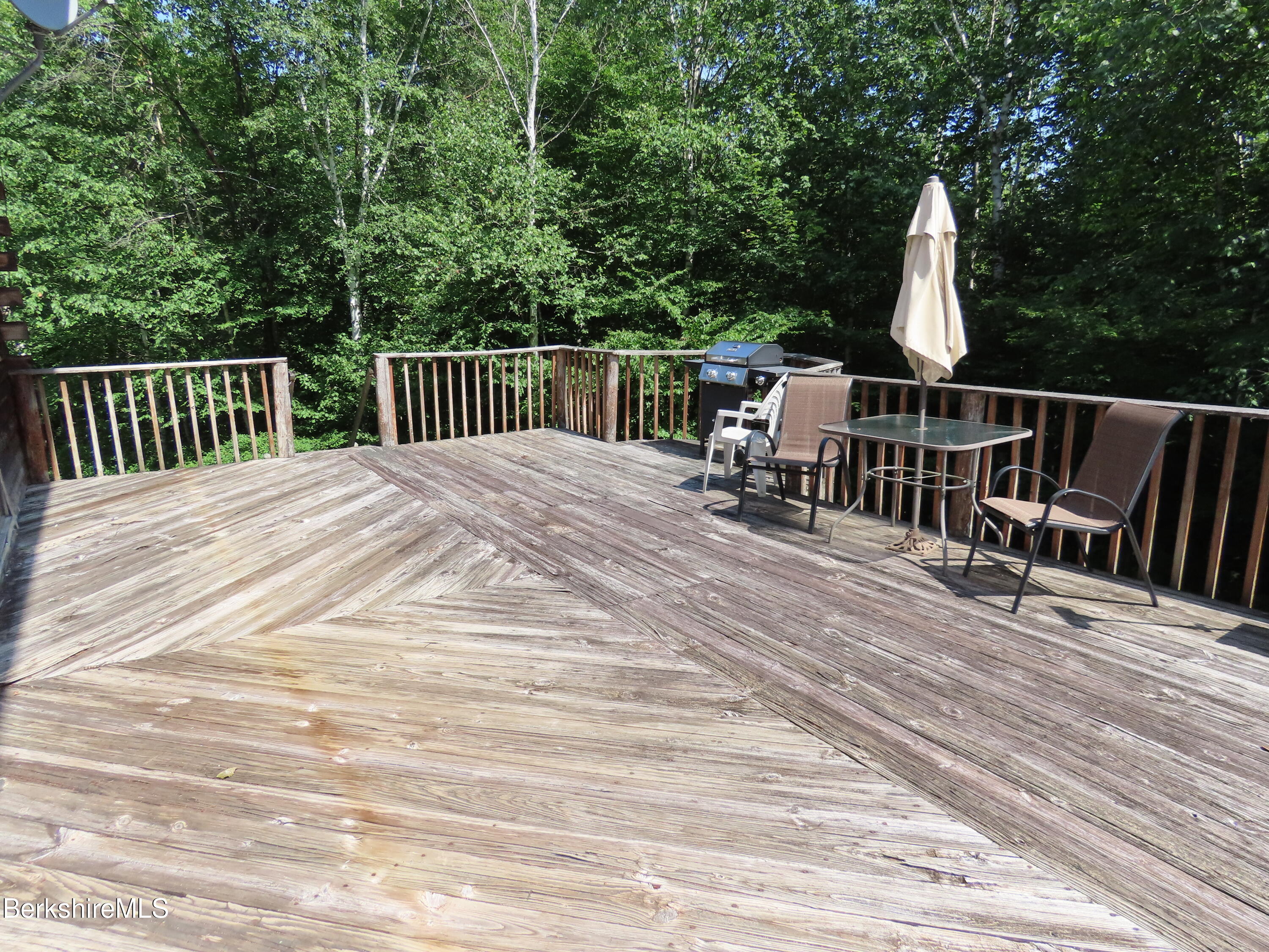 460 Sparrow Drive Stamford, VT 05352 - Photo 60 of 79 a view of a deck with two chair and wooden floor