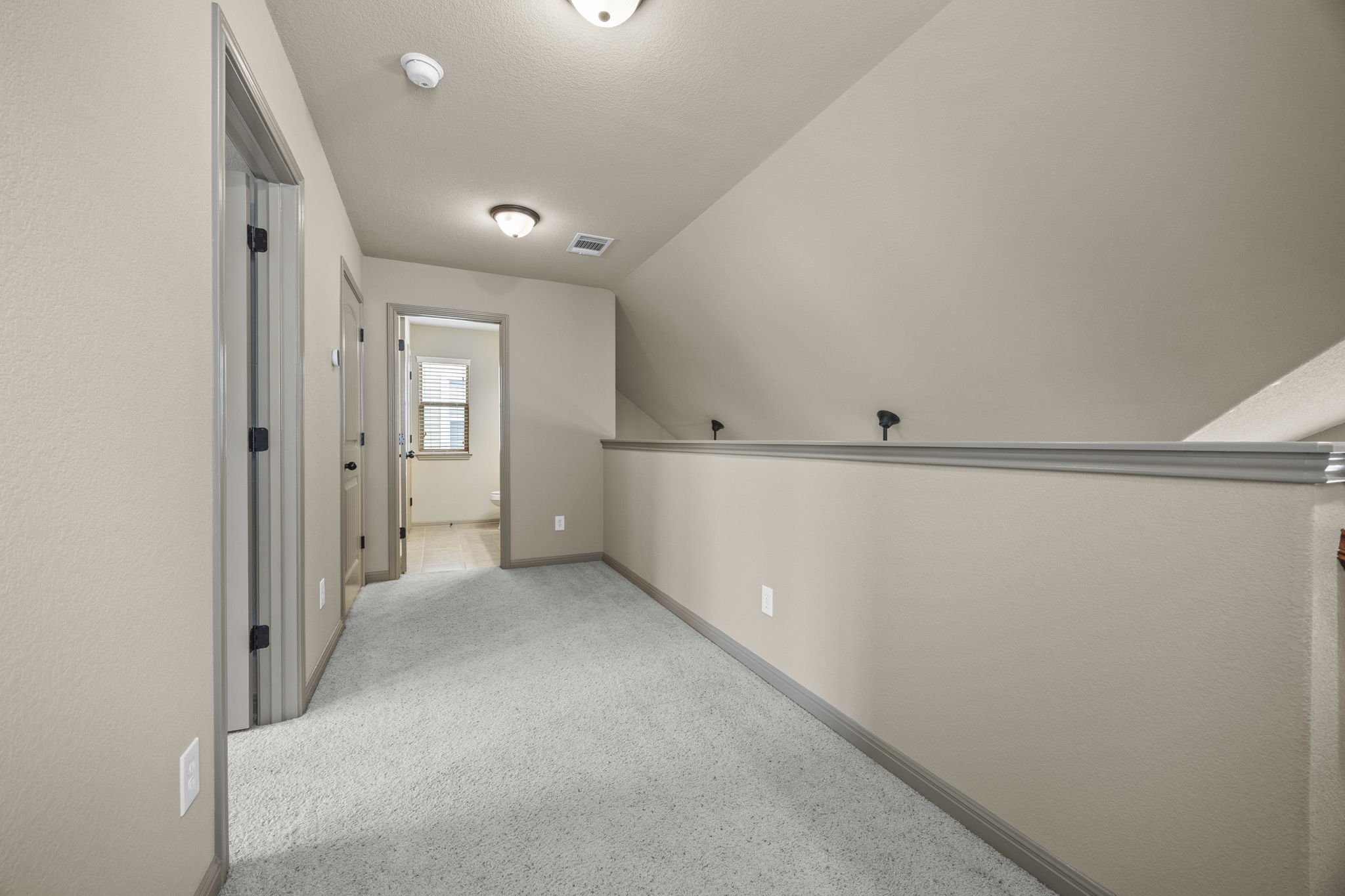 263 Cleveland Kyle, TX 78640 - Photo 13 of 20 Corridor to upstairs bedroom bath and laundry room