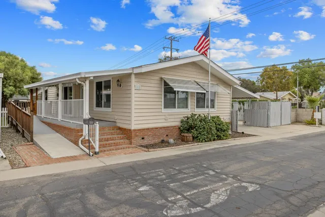 a backyard of a house with shaded area