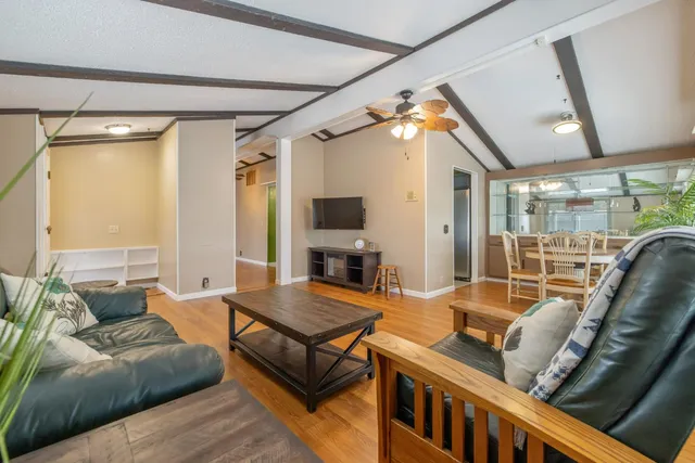 a dining room with furniture and wooden floor