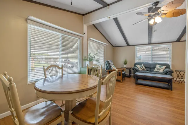 a view of a dining room with furniture and wooden floor