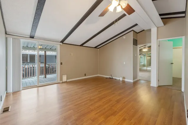 a view of a room with wooden floor and a window
