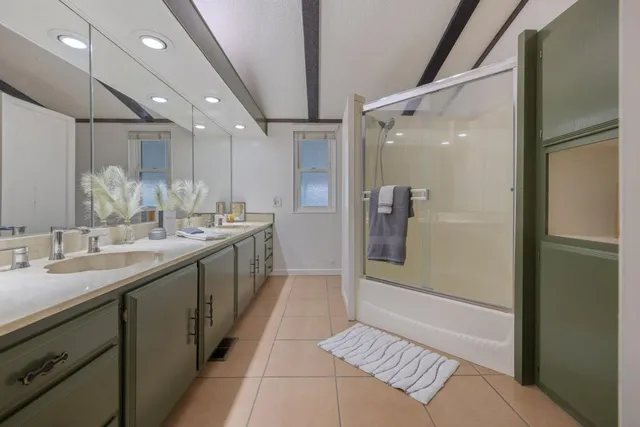 a bathroom with a sink double vanity and a mirror