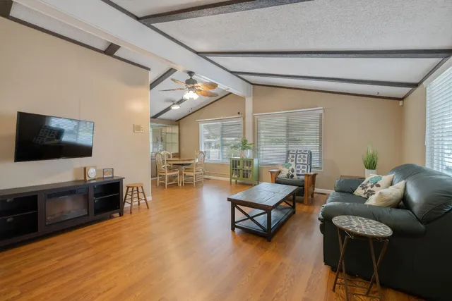 a living room with fireplace furniture and a wooden floor