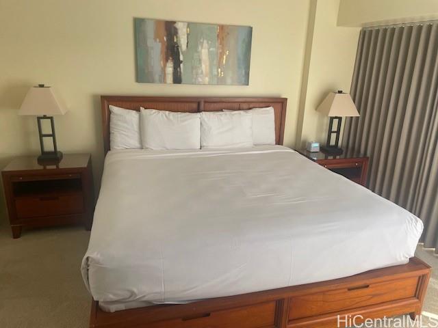 1088 Bishop Street, Unit 3606 Honolulu, HI 96813 - Photo 16 of 19 a bedroom with a bed and a night stand