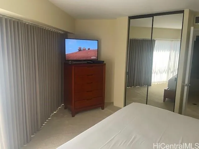 a bedroom with a bed and a mirror