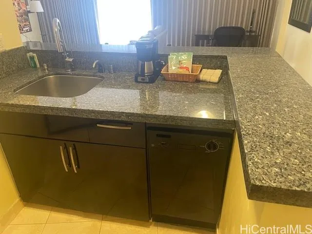 a kitchen with sink and granite counter tops