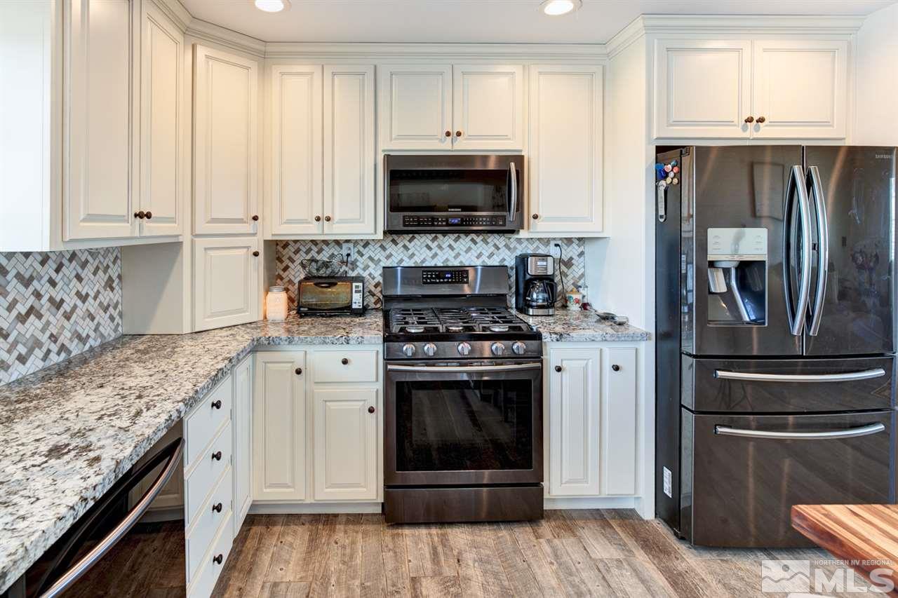 1525 Soda Lake Road Fallon, NV 89406 - Photo 8 of 40 a kitchen with a stove and a refrigerator