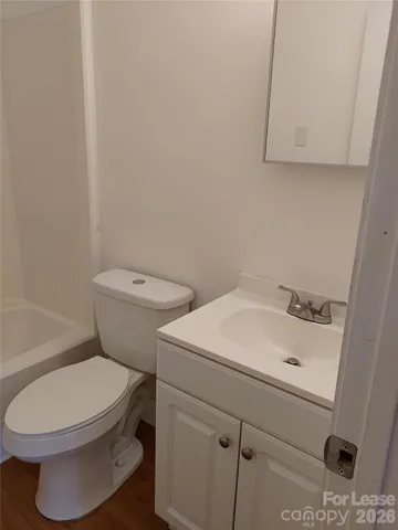 a white toilet sitting next to a bathroom sink