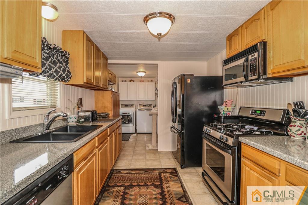 9 Morley Road, Unit 9 North Brunswick, NJ 08902 - Photo 1 of 19 a kitchen with stainless steel appliances granite countertop a sink stove and refrigerator