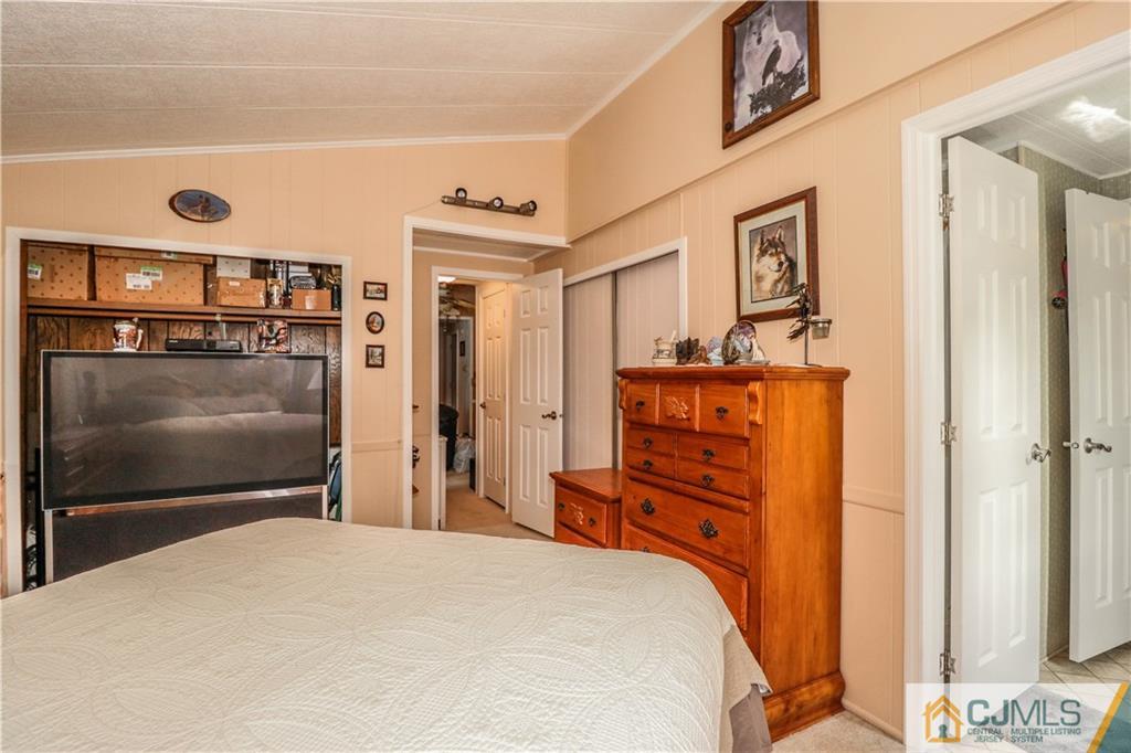 9 Morley Road, Unit 9 North Brunswick, NJ 08902 - Photo 11 of 19 a bedroom with a bed and a television