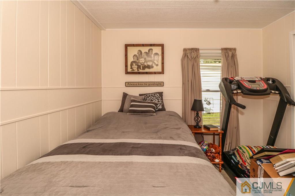 9 Morley Road, Unit 9 North Brunswick, NJ 08902 - Photo 13 of 19 a bedroom with a bed and wooden floor