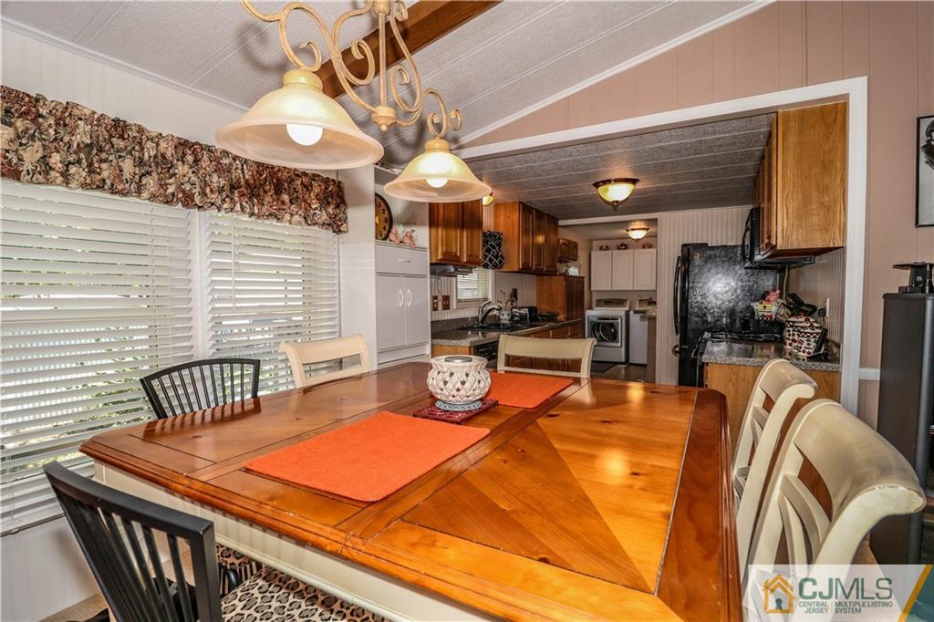 9 Morley Road, Unit 9 North Brunswick, NJ 08902 - Photo 3 of 19 a room with table chairs and a chandelier