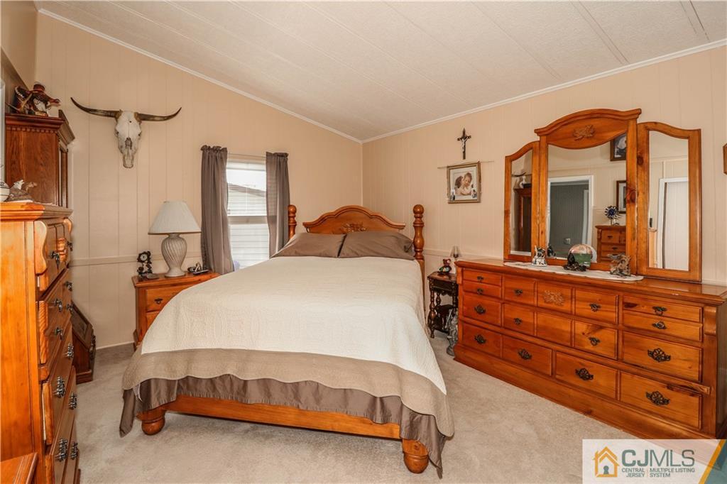 9 Morley Road, Unit 9 North Brunswick, NJ 08902 - Photo 4 of 19 a bedroom with a bed and a dresser