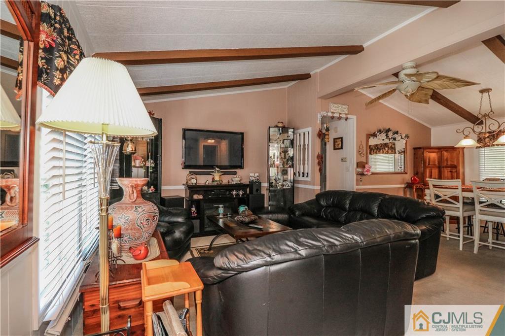 9 Morley Road, Unit 9 North Brunswick, NJ 08902 - Photo 5 of 19 a living room with furniture and a flat screen tv