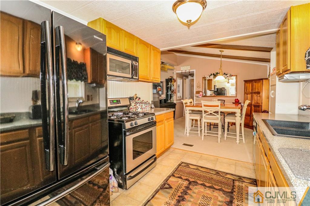 9 Morley Road, Unit 9 North Brunswick, NJ 08902 - Photo 8 of 19 a kitchen with stainless steel appliances granite countertop a stove and more cabinets