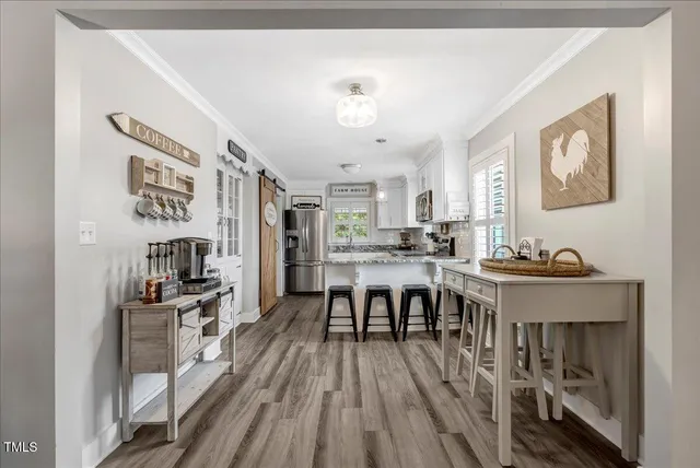 a view of a dining room with furniture and wooden floor