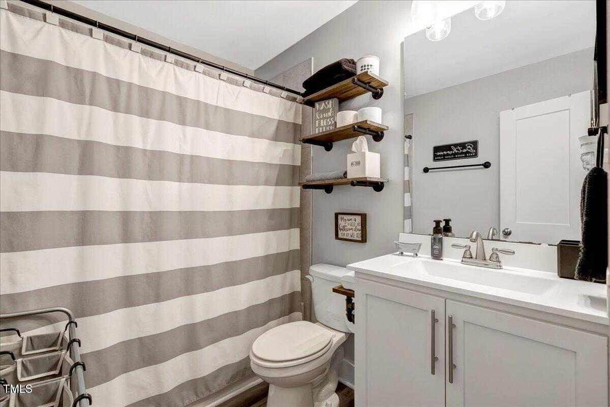 1856 Flat Rock Church Road Louisburg, NC 27549 - Photo 20 of 30 a bathroom with a sink toilet and shower