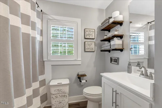 a bathroom with a toilet a sink and a shower