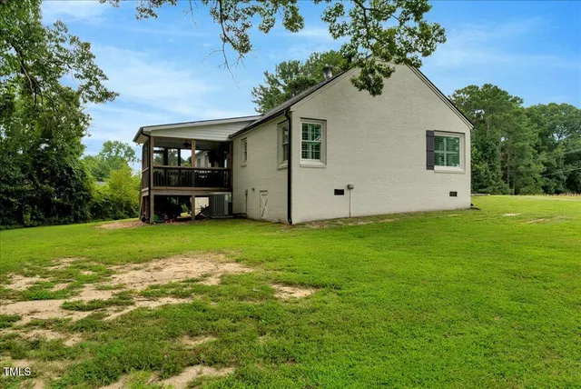 a front view of a house with a garden and yard