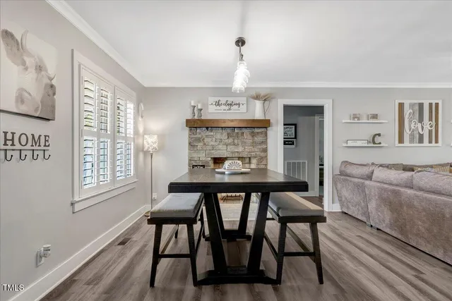 a view of a dining room with furniture window and wooden floor