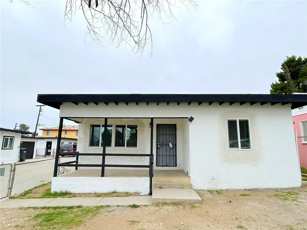 a view of a house with wooden fence
