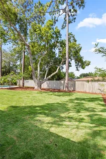 an aerial view of a house with garden space and street view