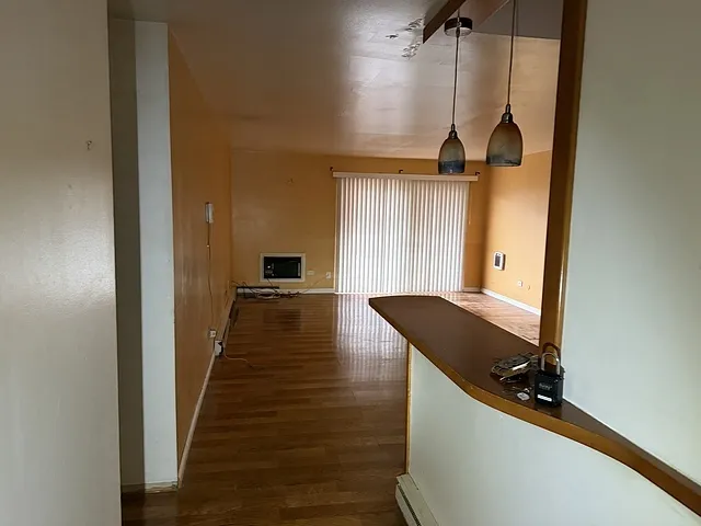 a view of a hallway with the kitchen
