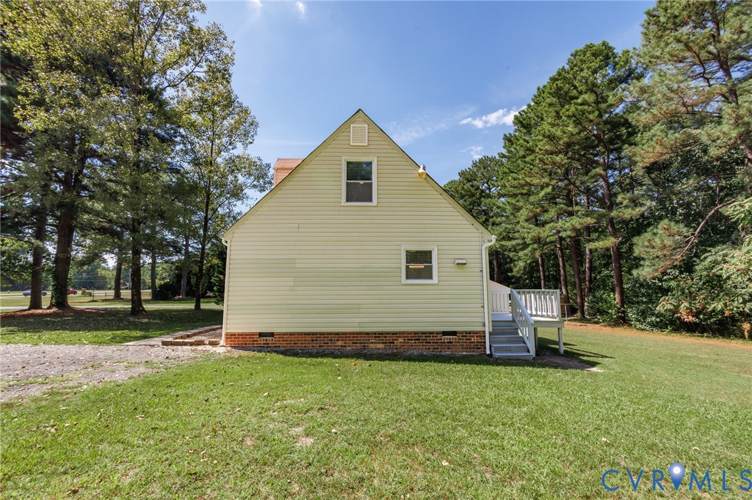 20520 Cox Road Sutherland, VA 23885 - Photo 29 of 31 Expansive green lawn, light-colored siding, red br