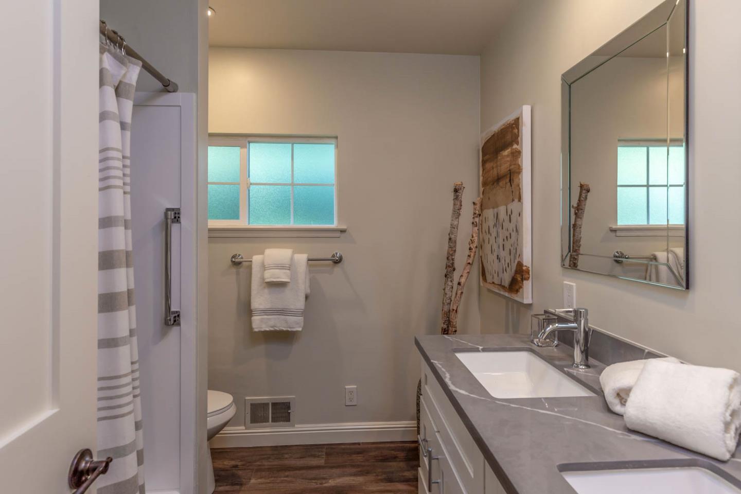610 Magdalena Avenue Los Altos, CA 94024 - Photo 19 of 38 a bathroom with a granite countertop sink a mirror and shower