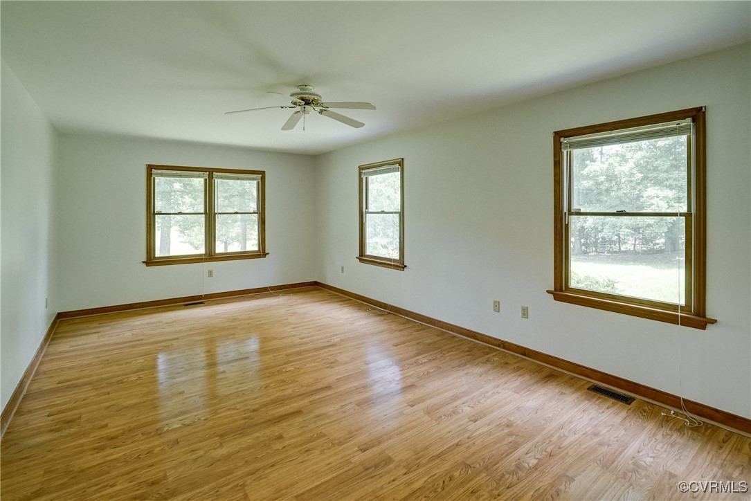 3175 Sandy Hook Road Sandy Hook, VA 23153 - Photo 16 of 27 a view of an empty room with a window and wooden floor