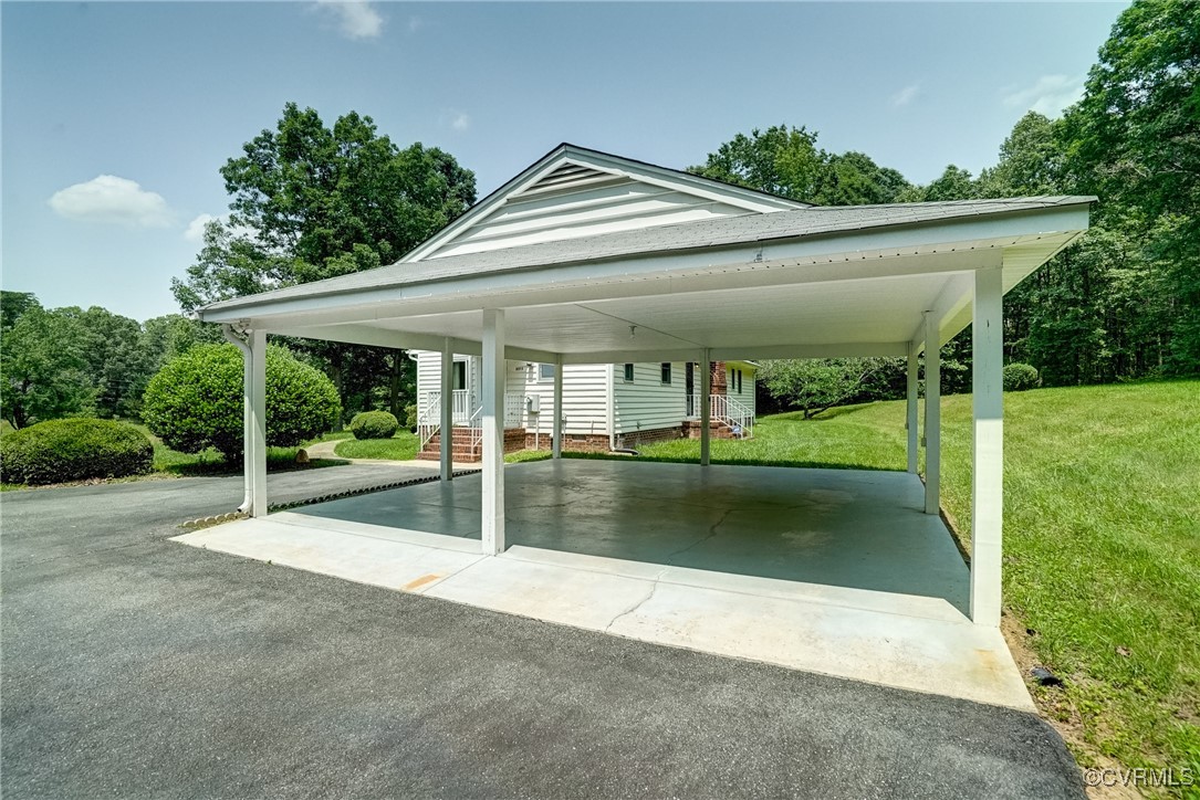 3175 Sandy Hook Road Sandy Hook, VA 23153 - Photo 23 of 27 a view of a patio with a table and chairs under an umbrella