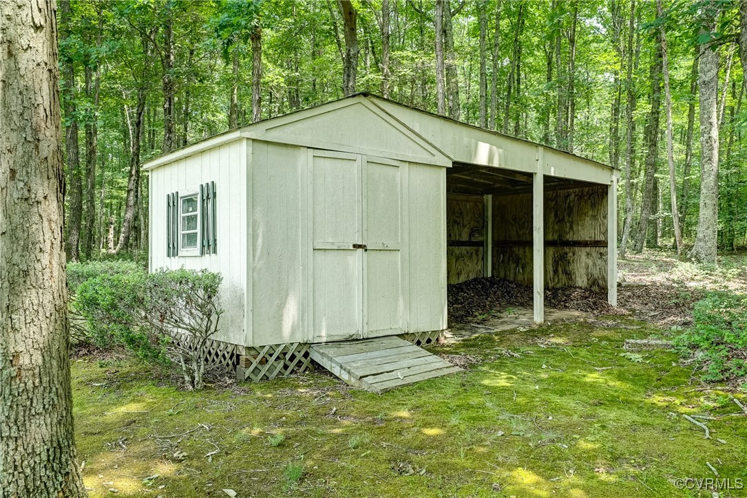 3175 Sandy Hook Road Sandy Hook, VA 23153 - Photo 24 of 27 a backyard of a house with barbeque oven and outdoor seating