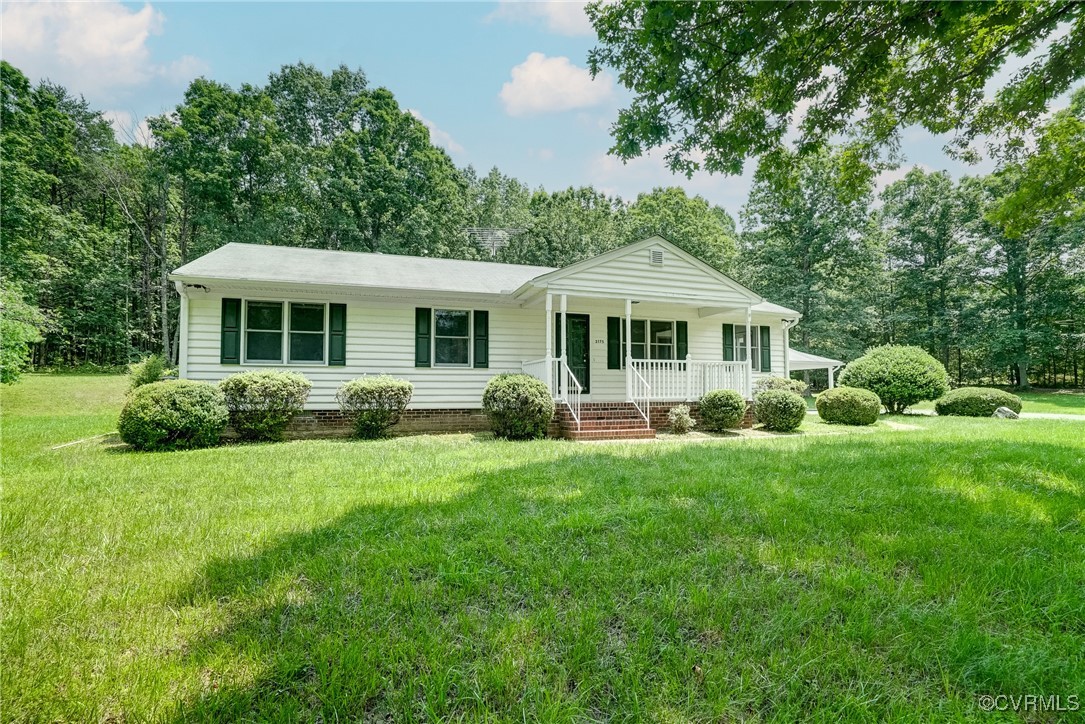 3175 Sandy Hook Road Sandy Hook, VA 23153 - Photo 27 of 27 a front view of a house with a yard and green space