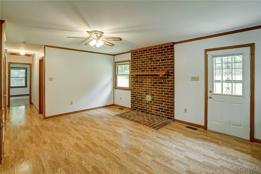 3175 Sandy Hook Road Sandy Hook, VA 23153 - Photo 7 of 27 an empty room with wooden floor chandelier fan and windows