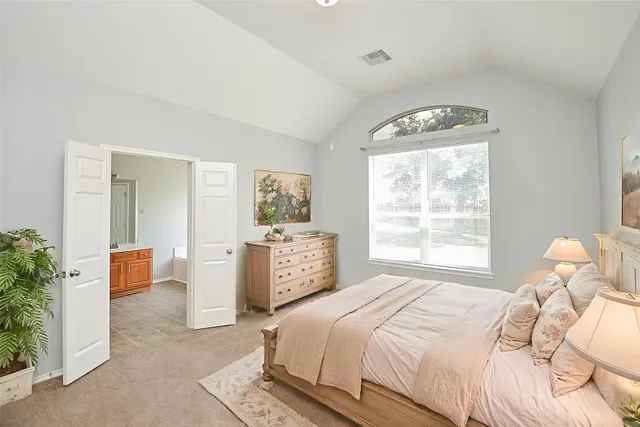 a bedroom with a bed and a potted plant