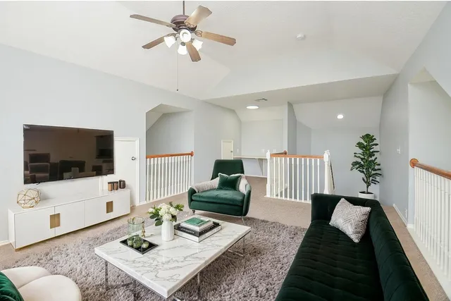 a view of an empty room with a ceiling fan