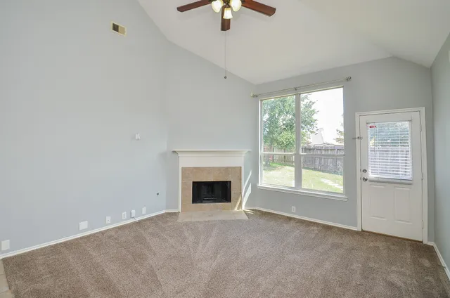 a view of empty room with fan and window